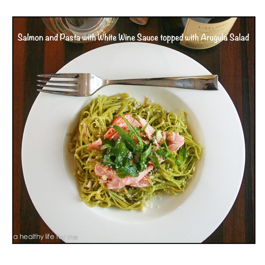 Salmon and Pasta with White Wine Sauce topped with an Arugula Salad