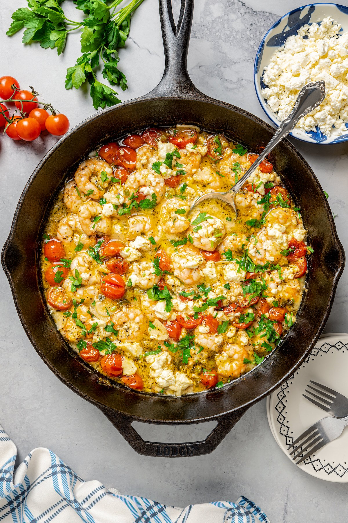 A skillet dish of shrimp and tomatoes.