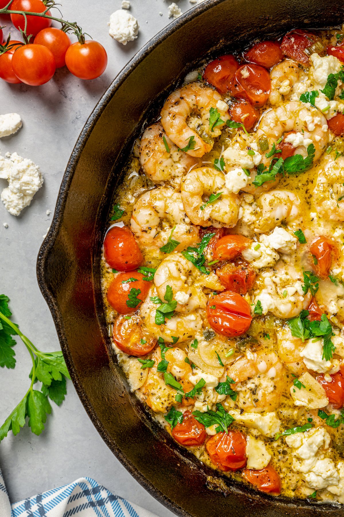 Close-up shot of baked shrimp with feta and tomatoes, to show the texture of the ingredients.