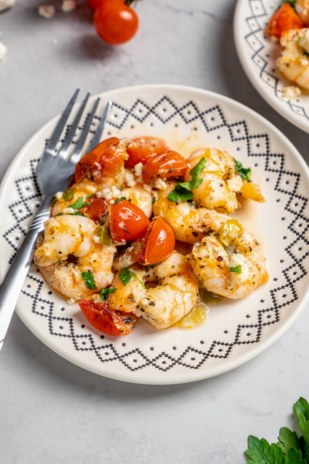 Baked shrimp served on a blue and white dinner plate.