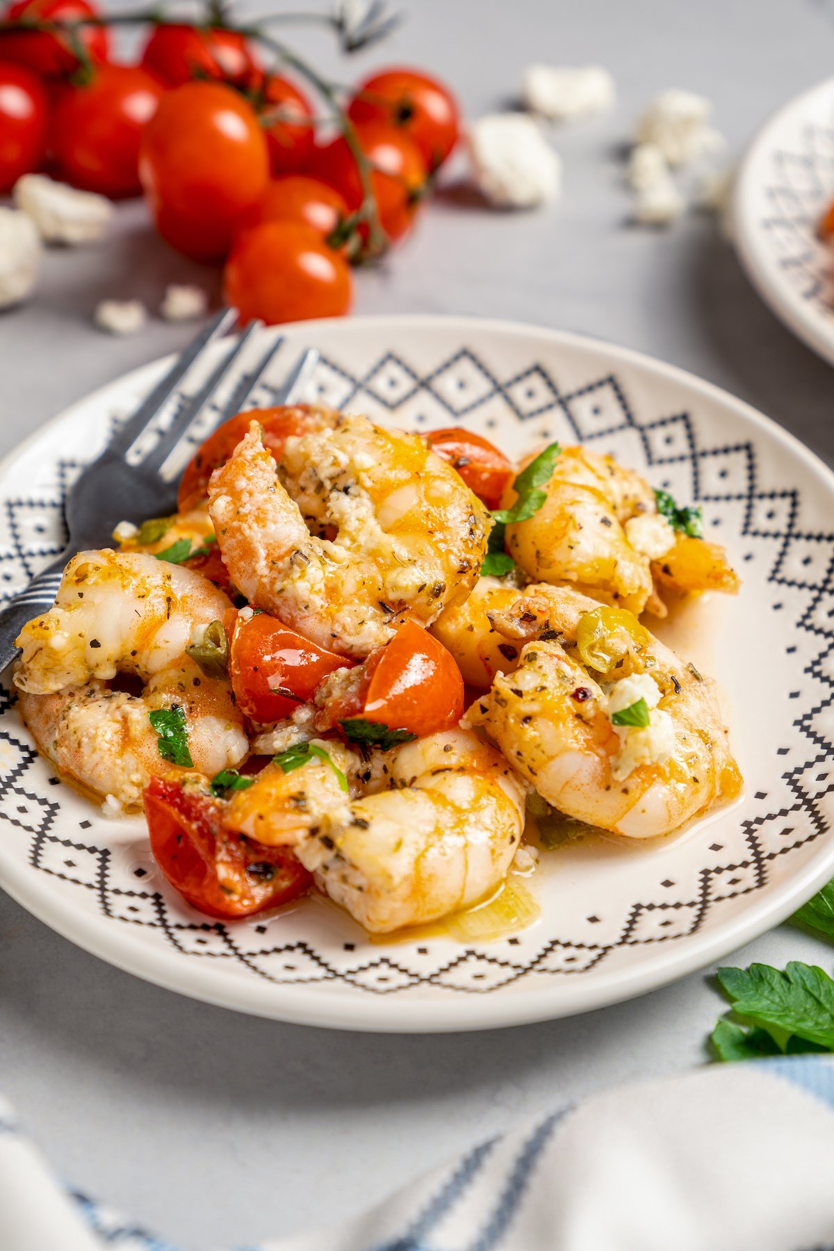 A plate of shrimp with tomatoes and feta.