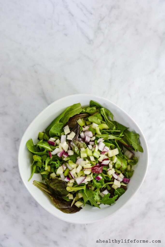 Chopped Italian Salad is loaded with crunchy raw vegetables and topped with a light lemon vinaigrette. The perfect all around healthy salad. Gluten Free, Paleo Friendly, Dairy Free, and Whole 30.