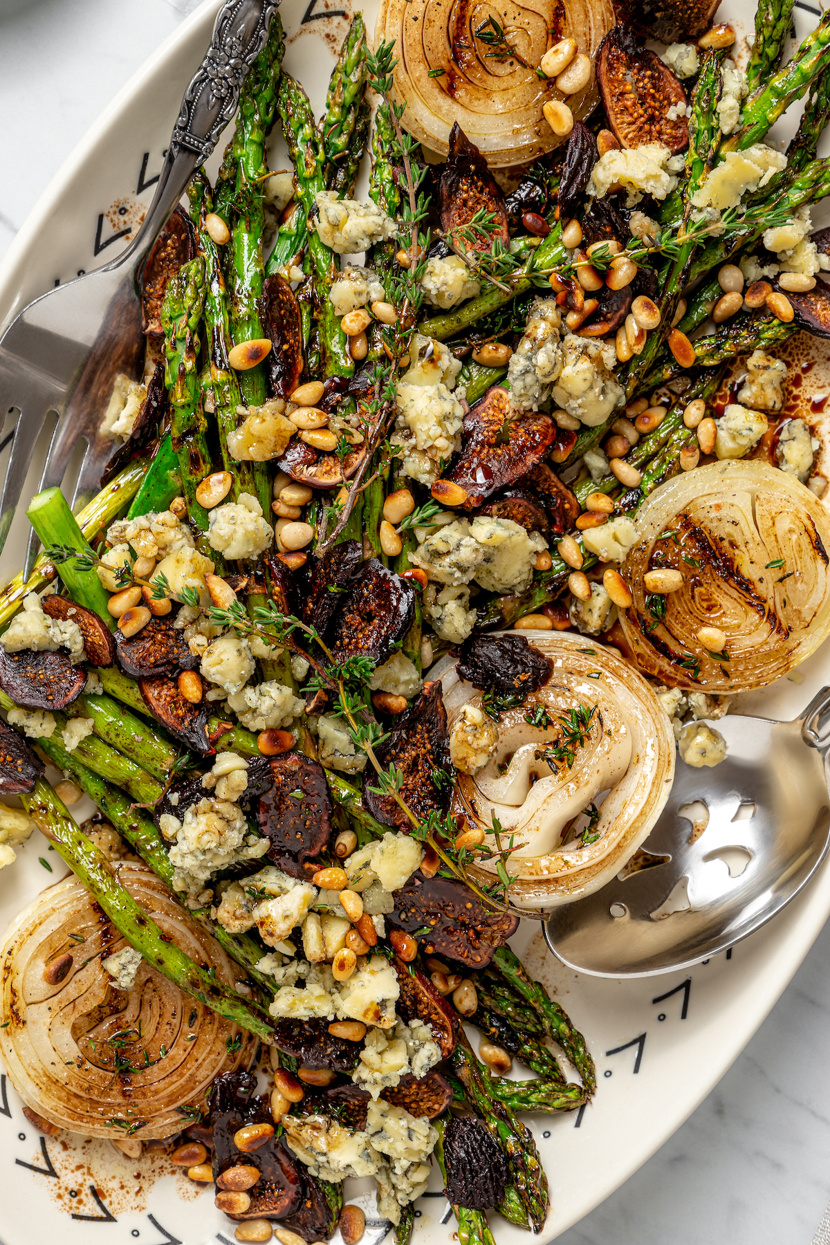 Close-up of asparagus and onion with blue cheese and other toppings.