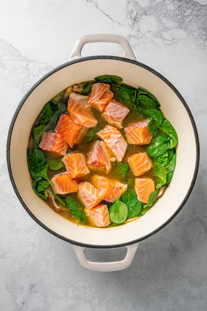Salmon and spinach added to soup.