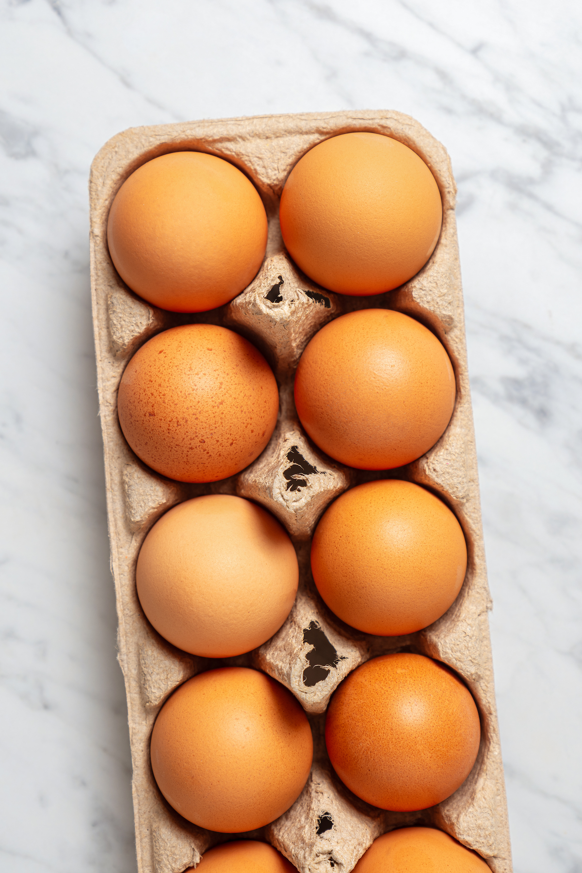 A carton of brown eggs.