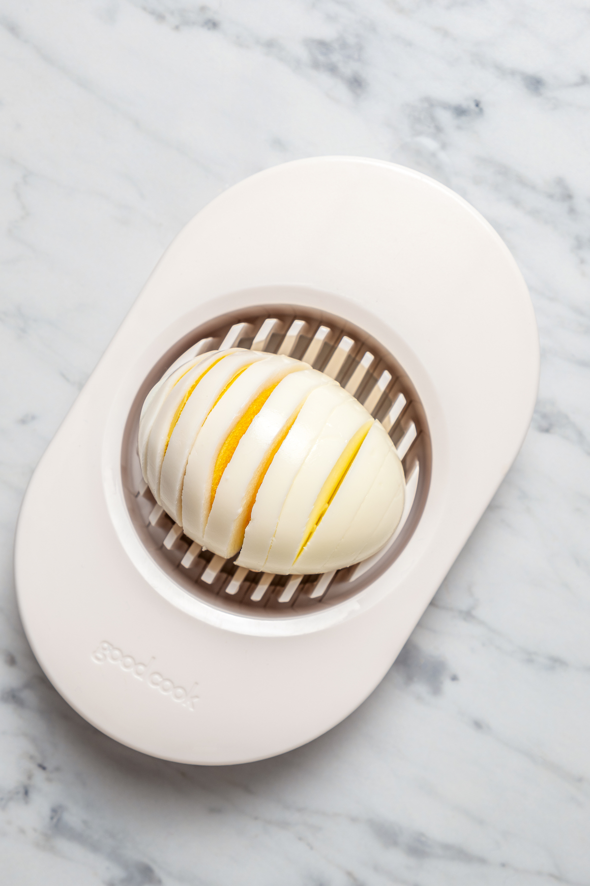 Cutting a boiled egg with an egg slicer.