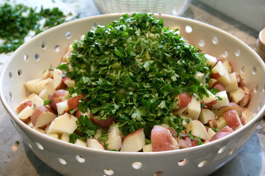 Adding the parsley and green onions to the potatoes. 