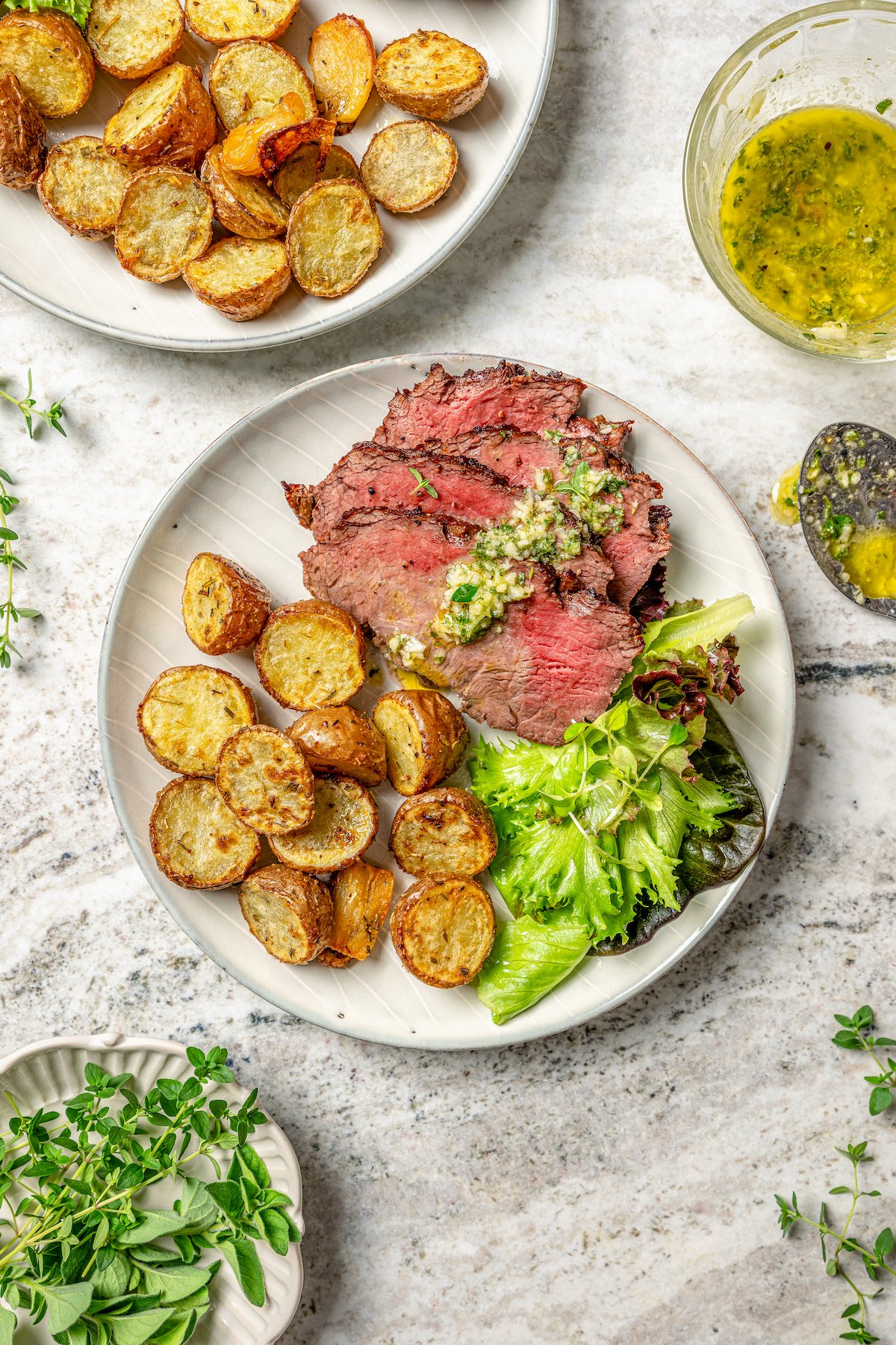 Sliced tri tip with herb sauce, roasted baby potatoes, and a fresh salad on the side. 