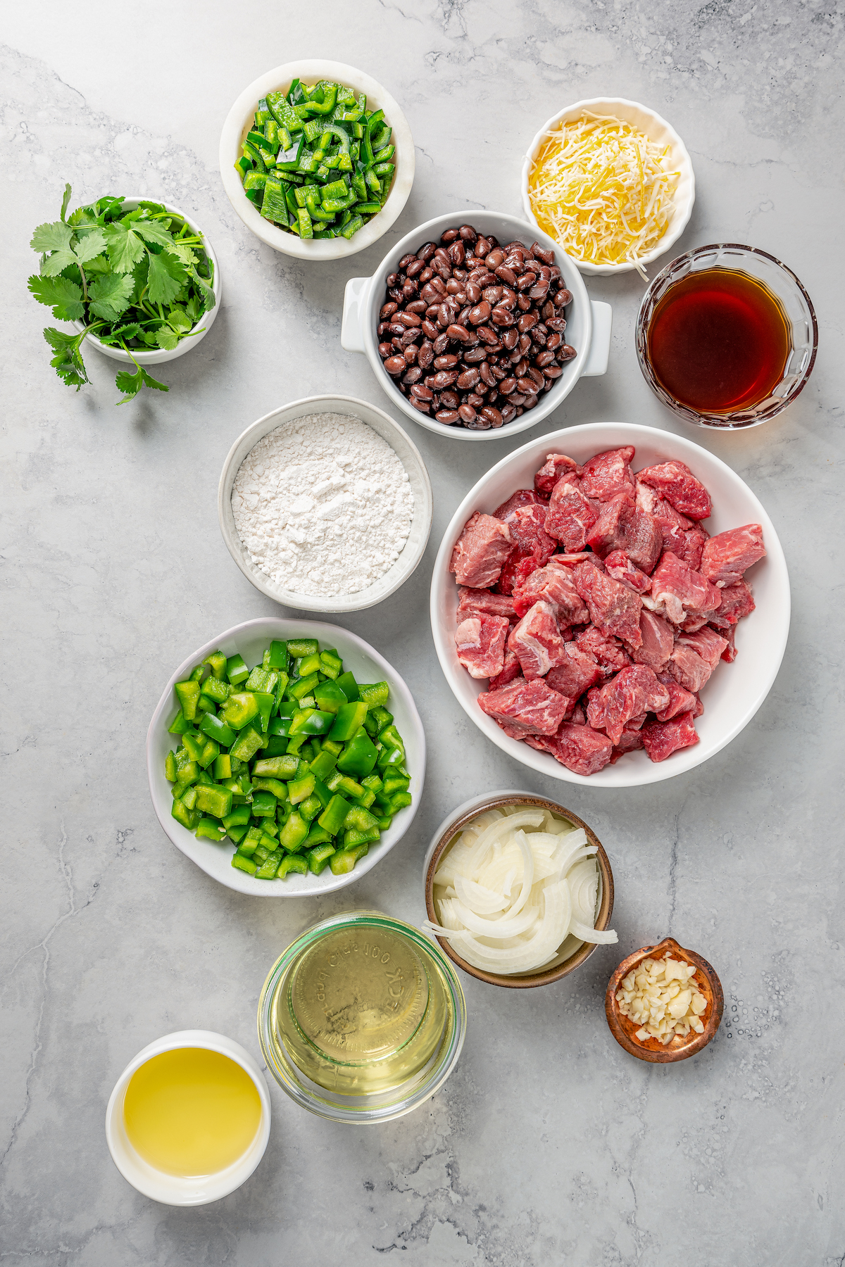 Brazilian beef stew ingredients measured and arranged on a work surface.