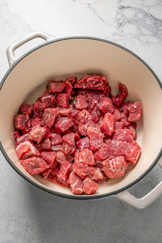 Beef chunks in a Dutch oven.