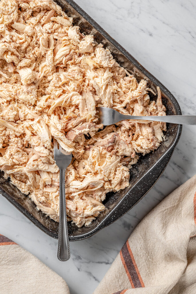 Shredded chicken in a pan.