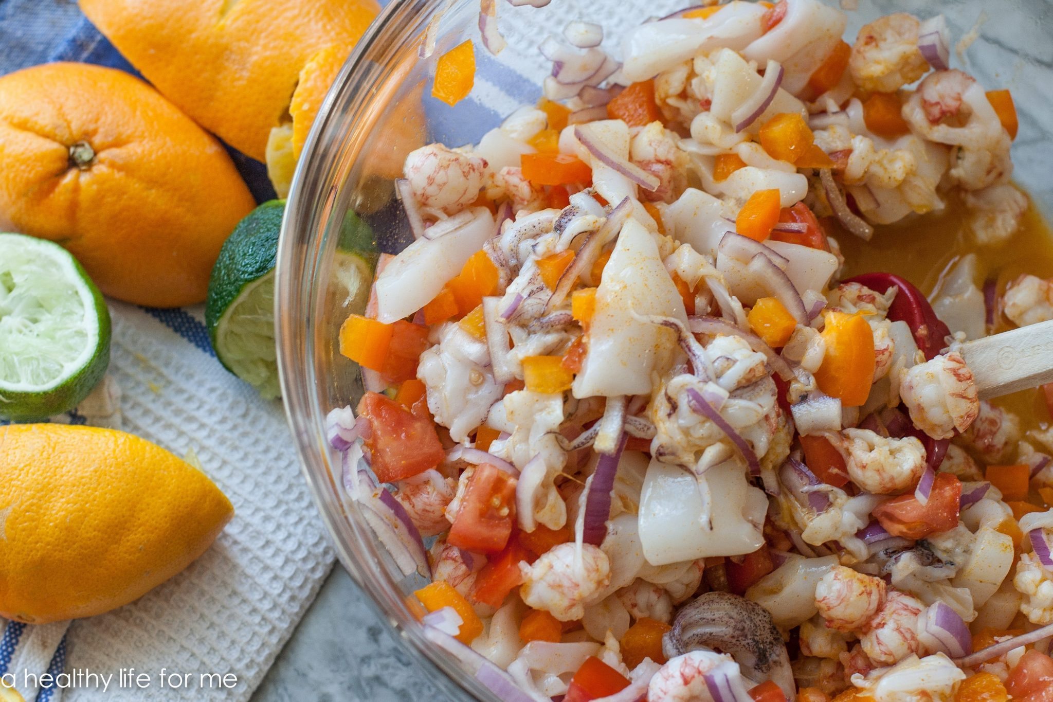 Langostino ceviche mixed in a bowl with citrus fruit