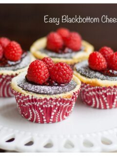 Four Black-Bottom Cheesecake Cupcakes on cake stand.