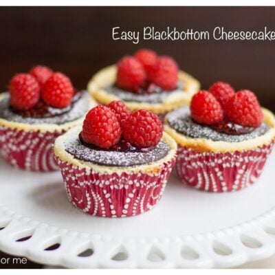 Four Black-Bottom Cheesecake Cupcakes on cake stand.