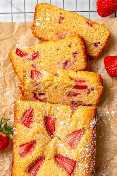 Sliced strawberry loaf dusted with powdered sugar.