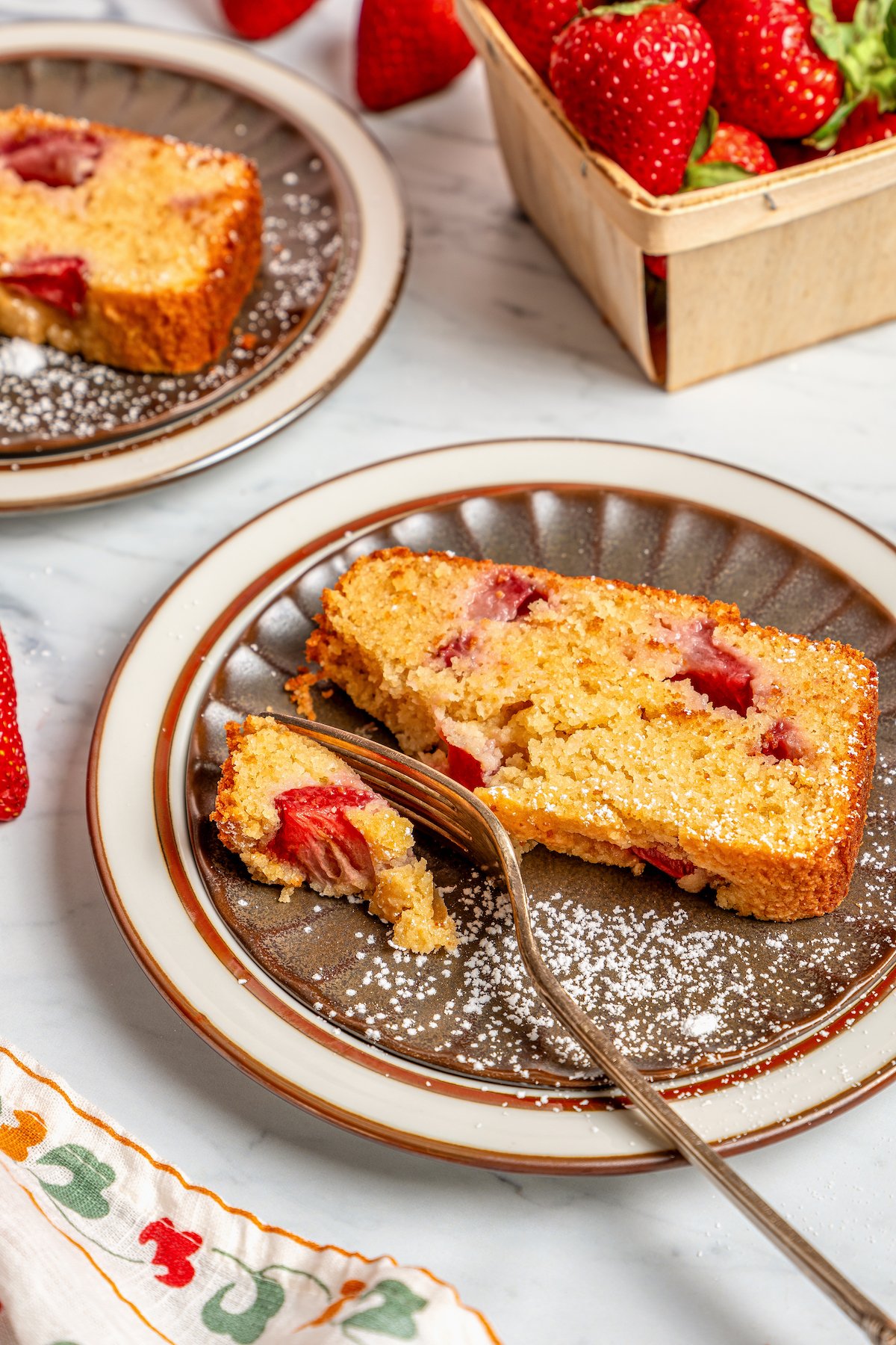 Grabbing a piece of buttery strawberry bread with a fork. 