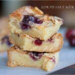 Three stacked almond bars with cherries.