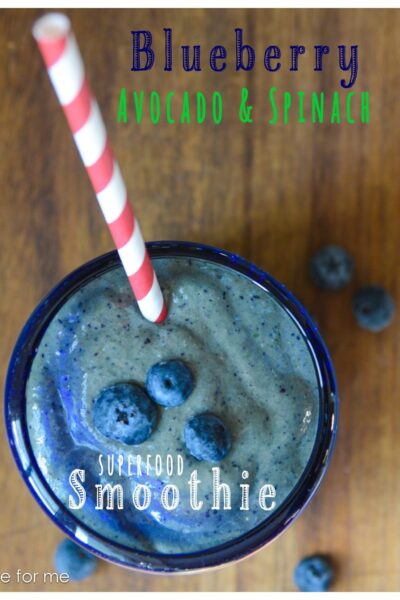 Blueberry Avocado Spinach Smoothie with a straw.