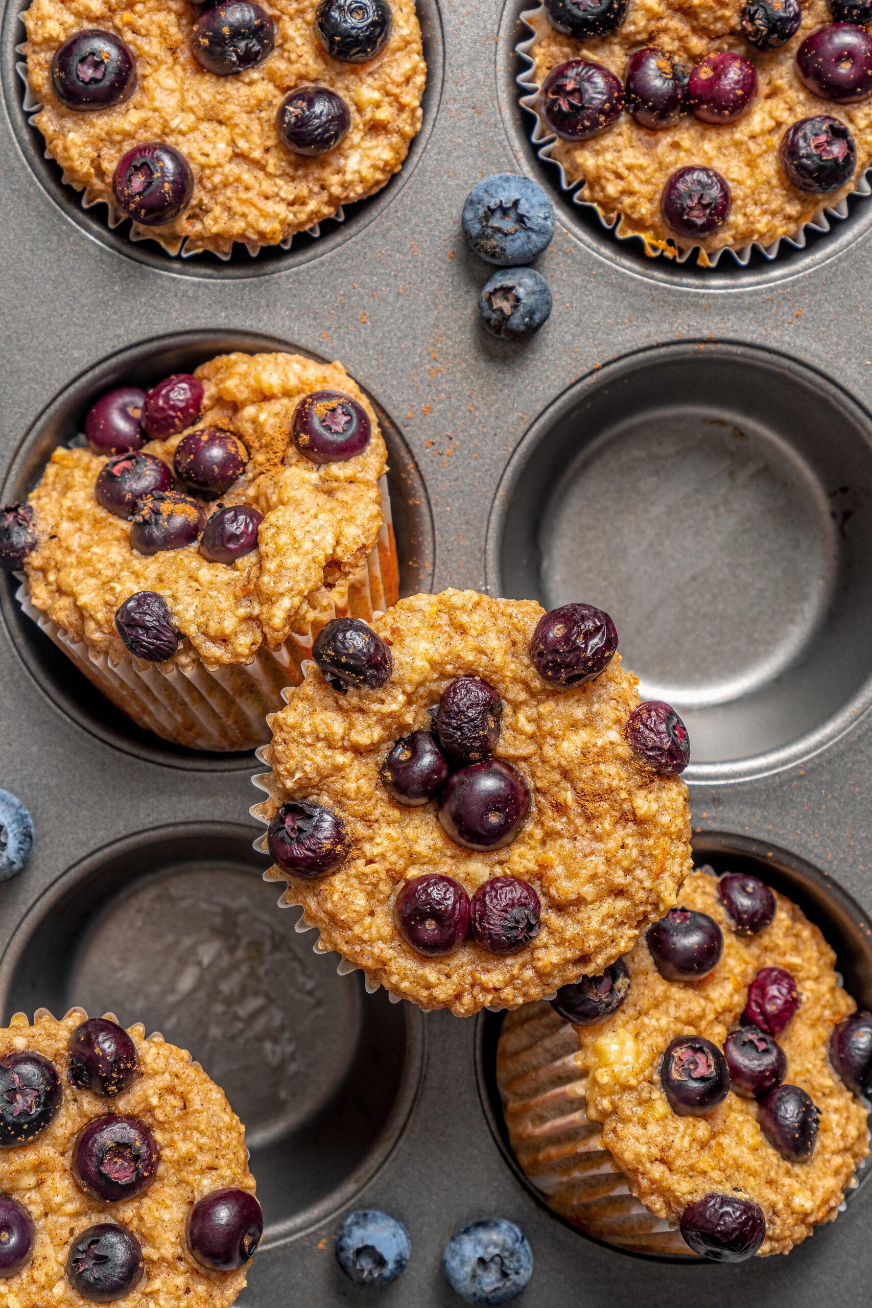 Freshly baked blueberry protein muffins in the muffin tray. 