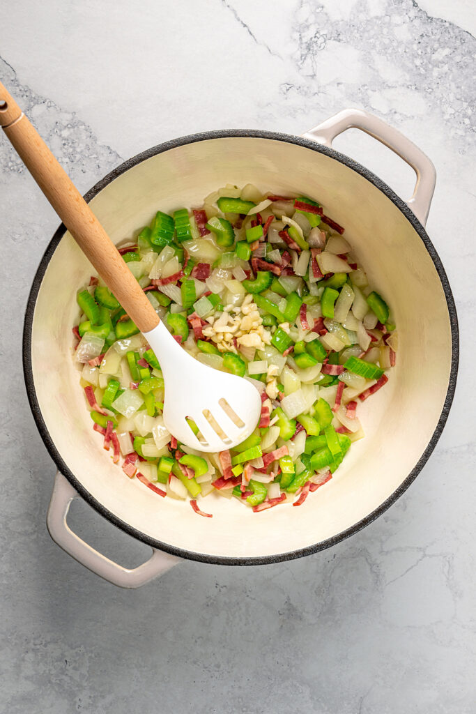 Cooking garlic with onion, celery, and turkey bacon.