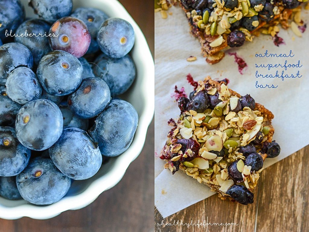 Bowl of blueberries to the left. Baked oatmeal bars to the right.