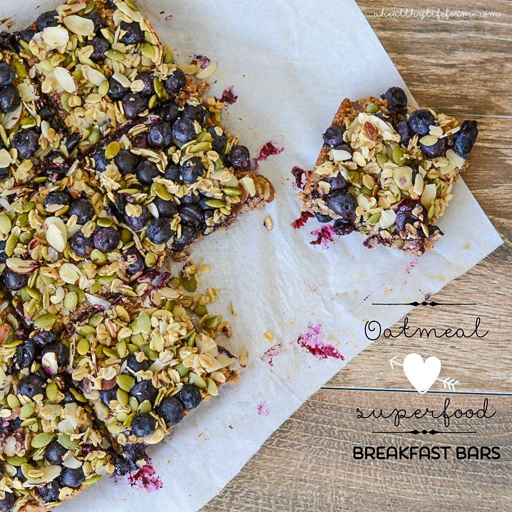 Sliced oatmeal breakfast bars on a piece of parchment paper.