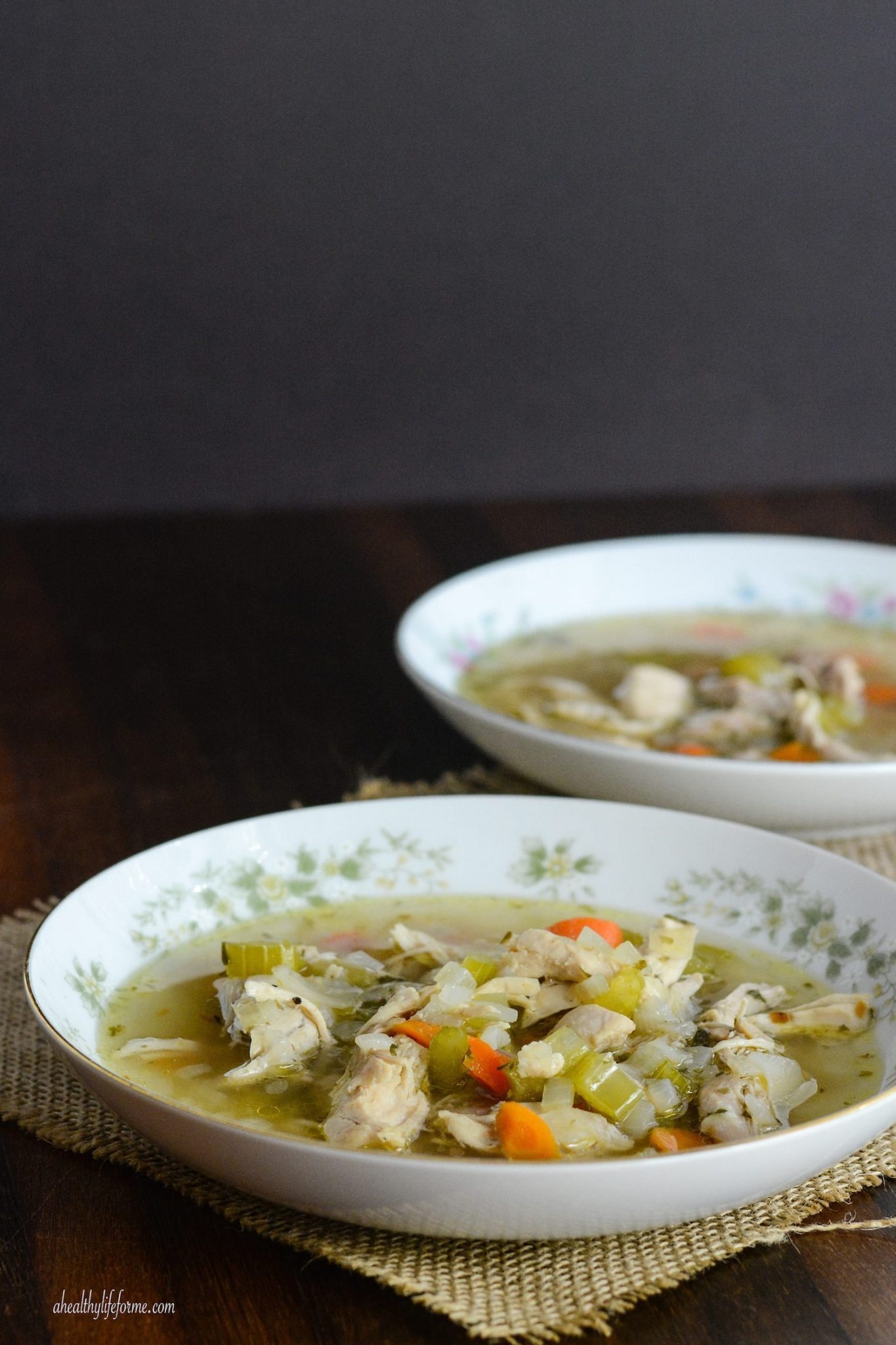 Side view of paleo chicken soup in a bowl. 