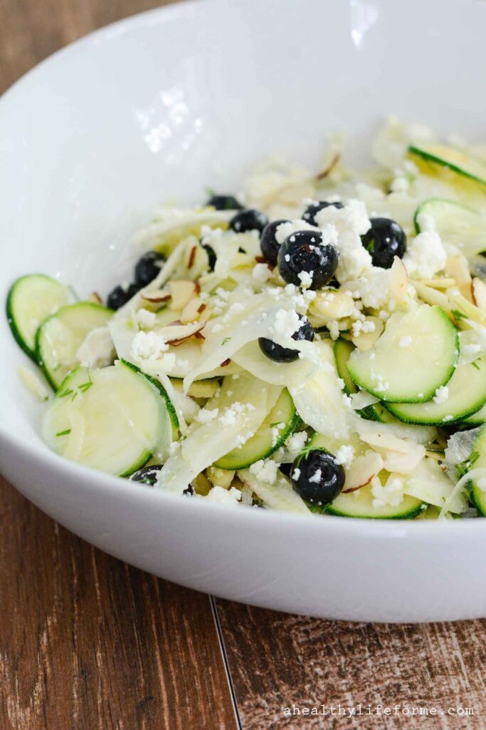 Shaved Fennel Zucchini Salad topped with Blueberries Feta Almonds and Lemon Vinaigrette | ahealthylifeforme.com