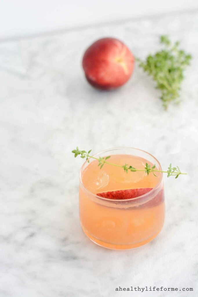 Peach Bourbon Thyme Smash Cocktail Recipe made with fresh peaches and jalapeno simple syrup | ahealthylifeforme.com