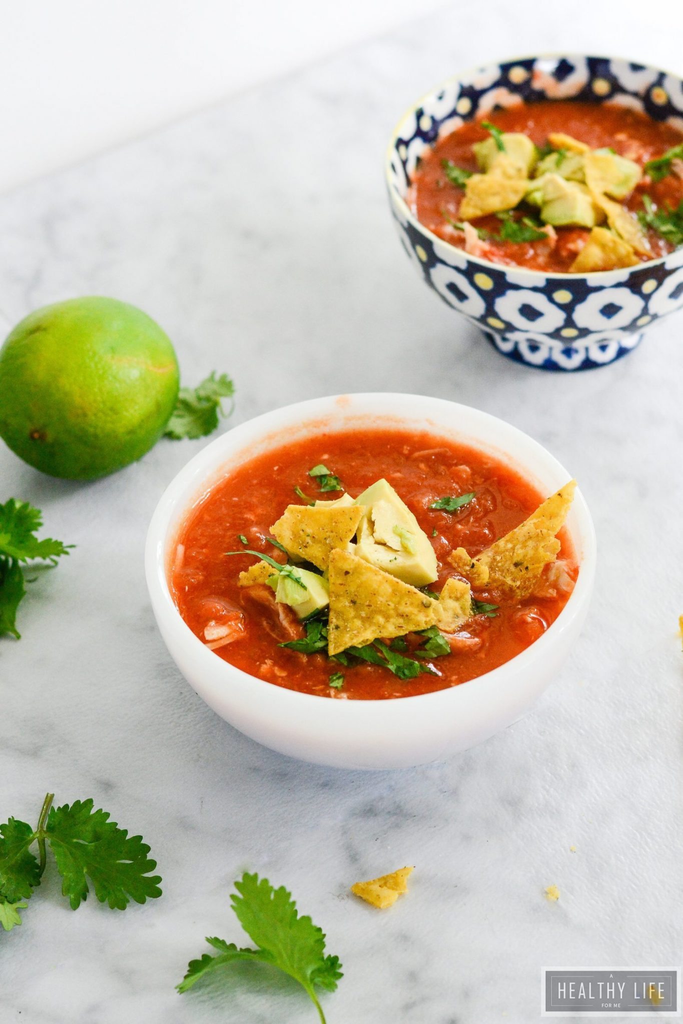Bowl of Mexican soup with toppings. 