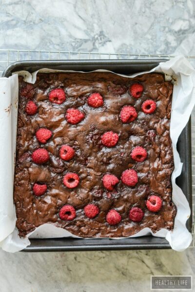 These Gluten Free Double Chocolate Raspberry Brownies are a decadent moist and rich brownie with a little bit of healthy berry goodness rolled up inside and thrown on top | ahealthylifeforme.com