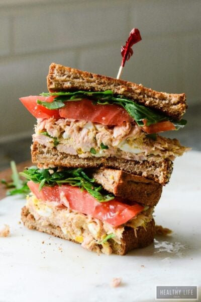 This Yellowfin Tuna Salad Sandwich made with high quality tuna, egg, dijon, a bit of spice all a top the perfectly toasted piece of bread and then topped with greens and a slice of heirloom tomato may be the best tuna salad sandwich ever | ahealthylifeforme.com