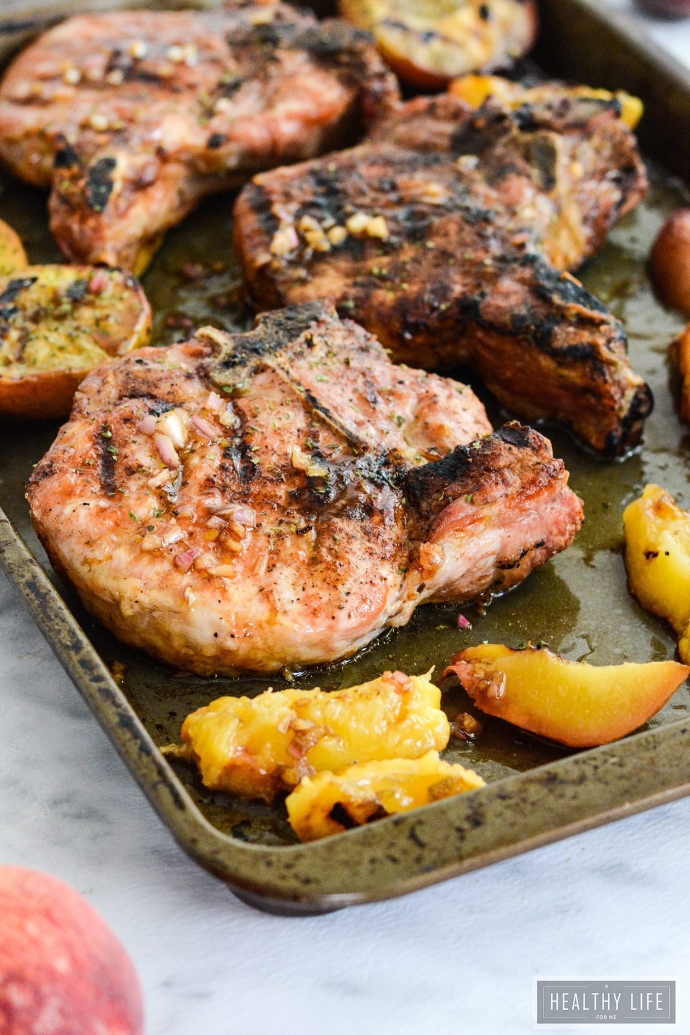 Grilled pork chops on sheet pan with peaches