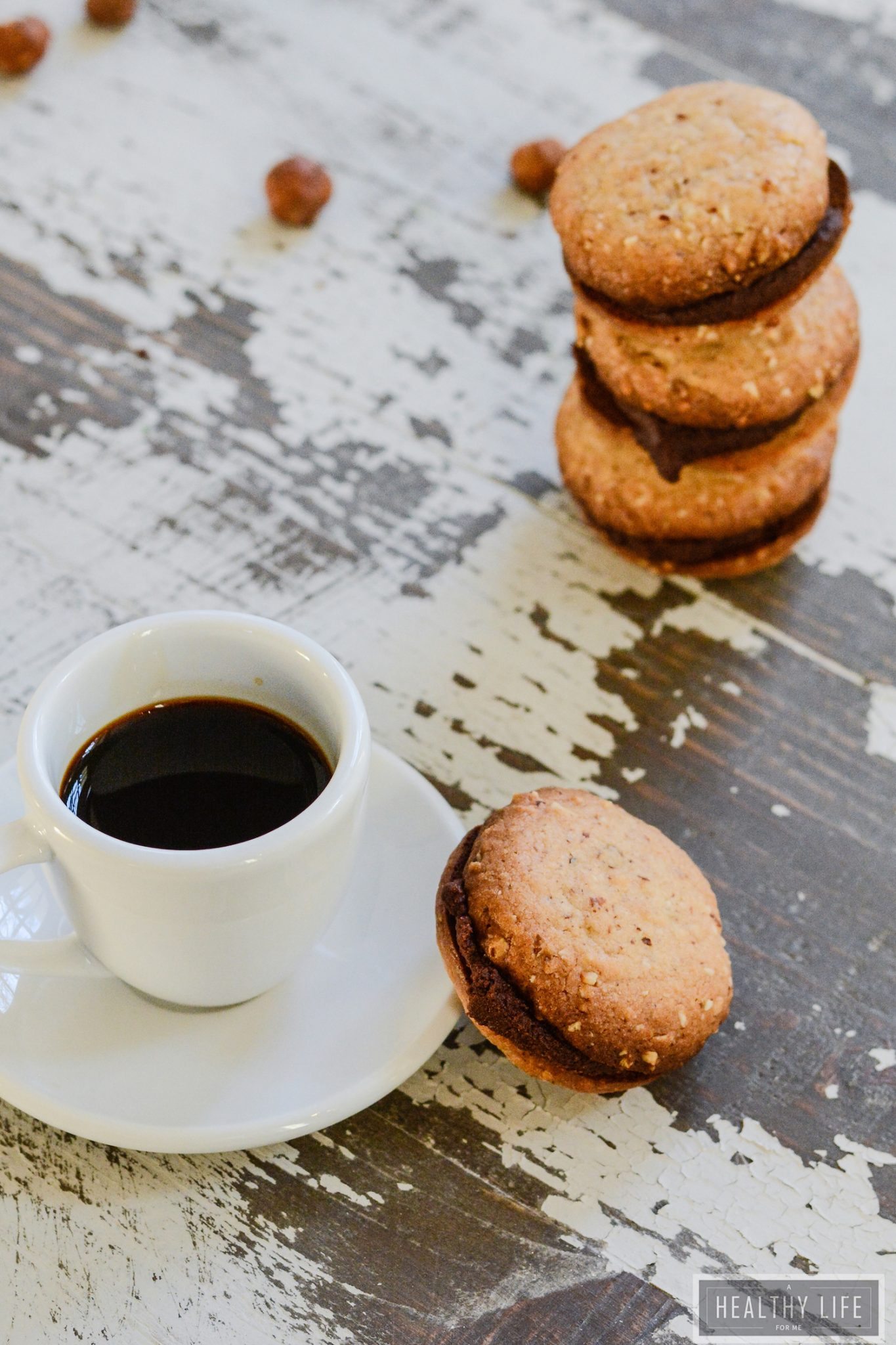 Hazelnut cookies with a cup of coffee on the side.