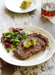 Grilled bison steak with a side salad.