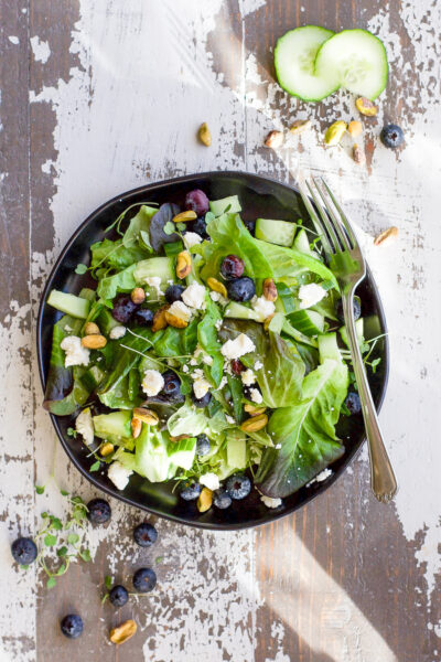 Overhead view of Spring Mix Salad Recipe with Blueberry Pistachio and Champagne Dressing