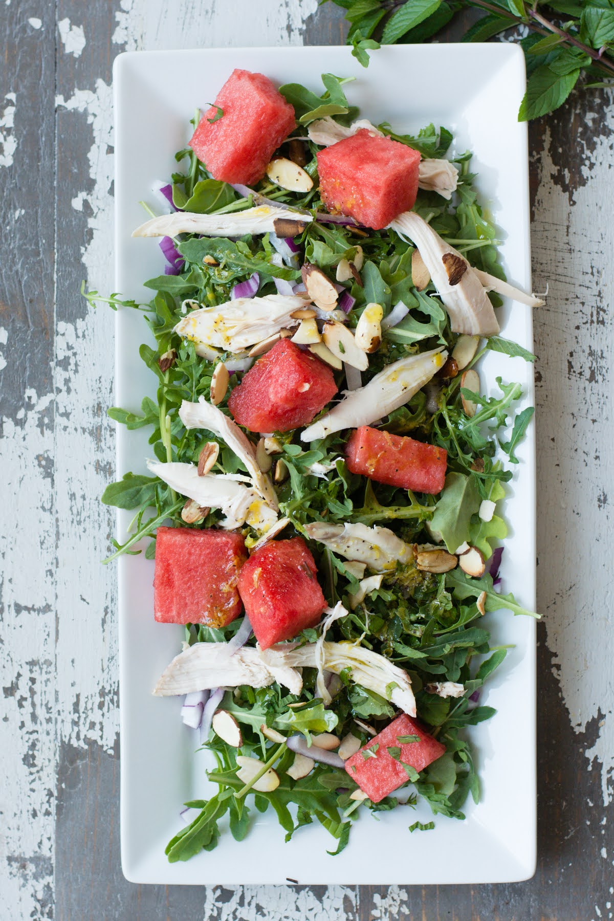 Overhead view of watermelon and arugula chicken salad