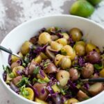 Ginger sesame potato salad in serving bowl with spoon