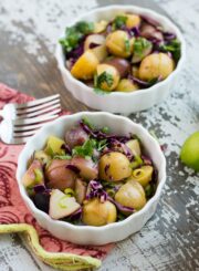 Two bowls of ginger sesame potato salad on rustic table