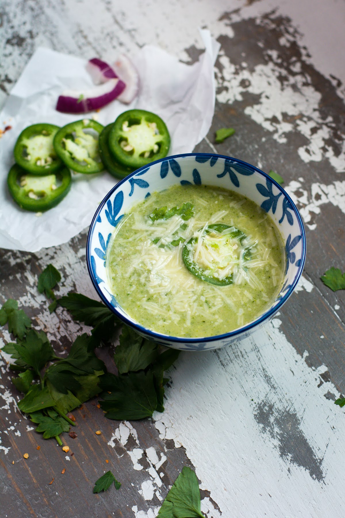 A bowl of creamy broccoli white bean soup with jalepenos and parmesan cheese