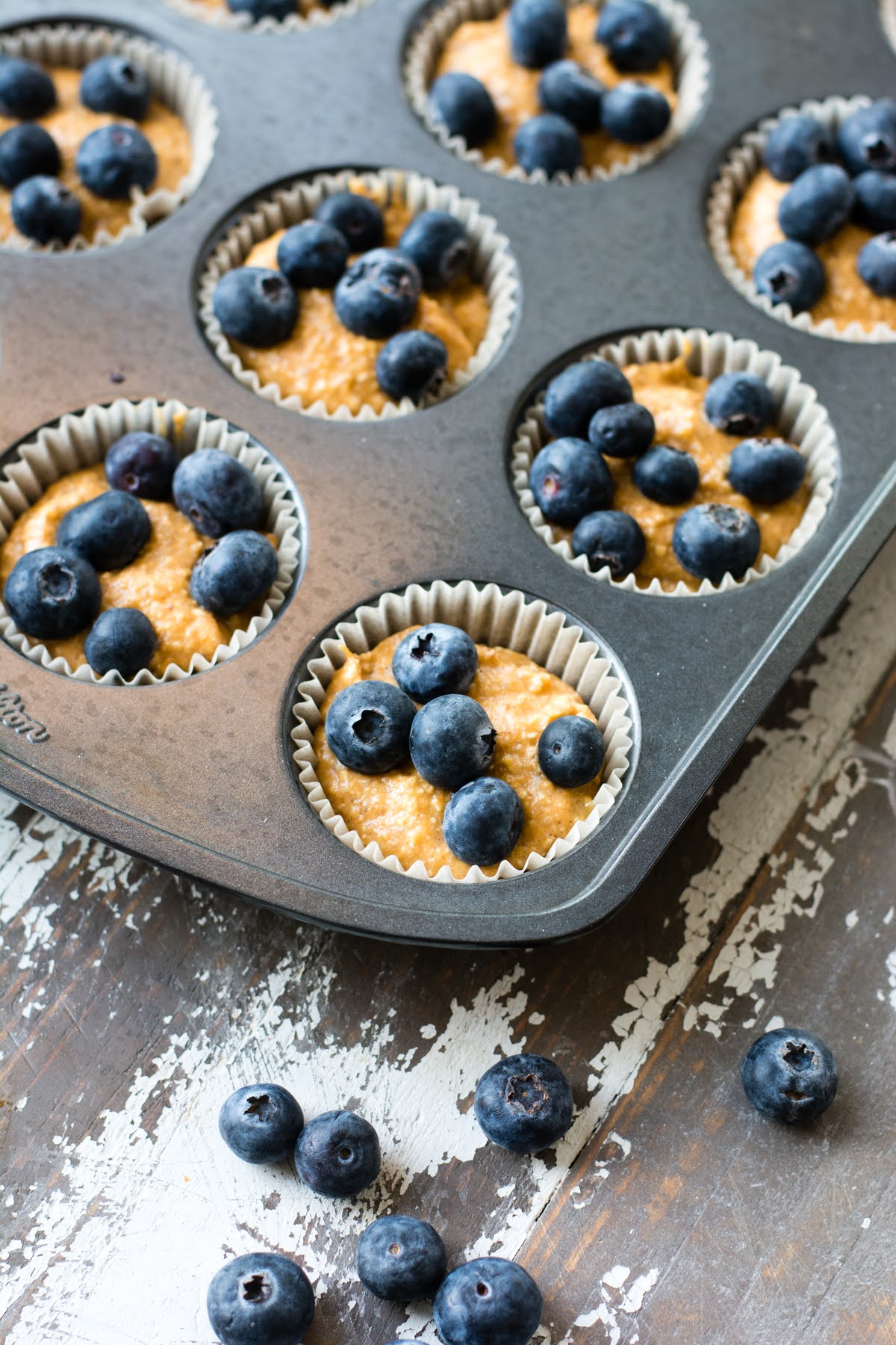 Blueberries on top of the muffin batter