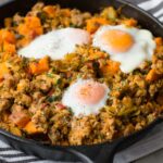 Brussels sprout sweet potato hash topped with baked eggs