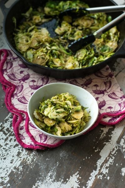 A bowl of brussels sprouts in front of the rest of the pan