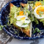 Avocado toast with egg and microgreens.