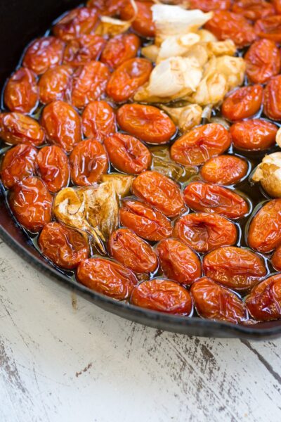 Roasted tomatoes in oil with garlic and shallot.