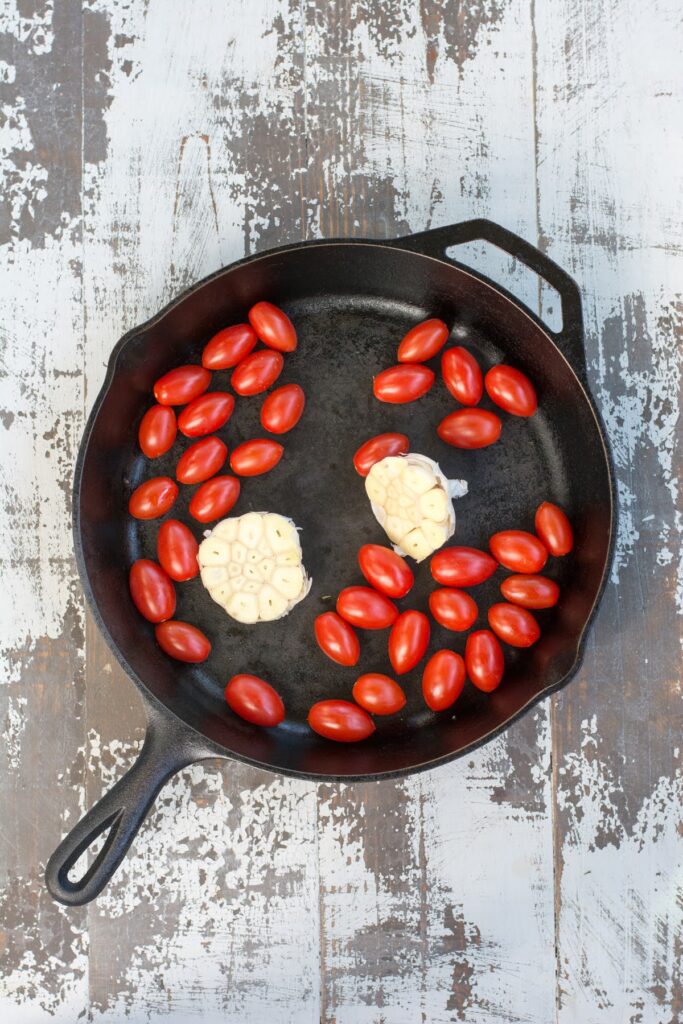 Tomatoes and garlic in a skillet.