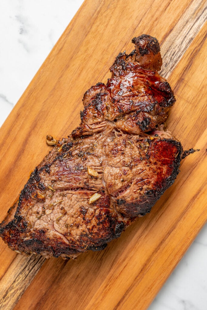 A steak on a cutting board.