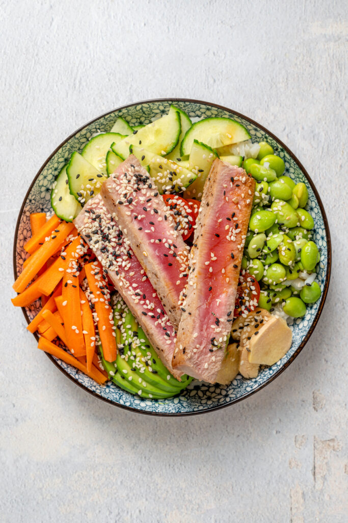 A sushi bowl with sesame seeds, tuna, avocado, and more.