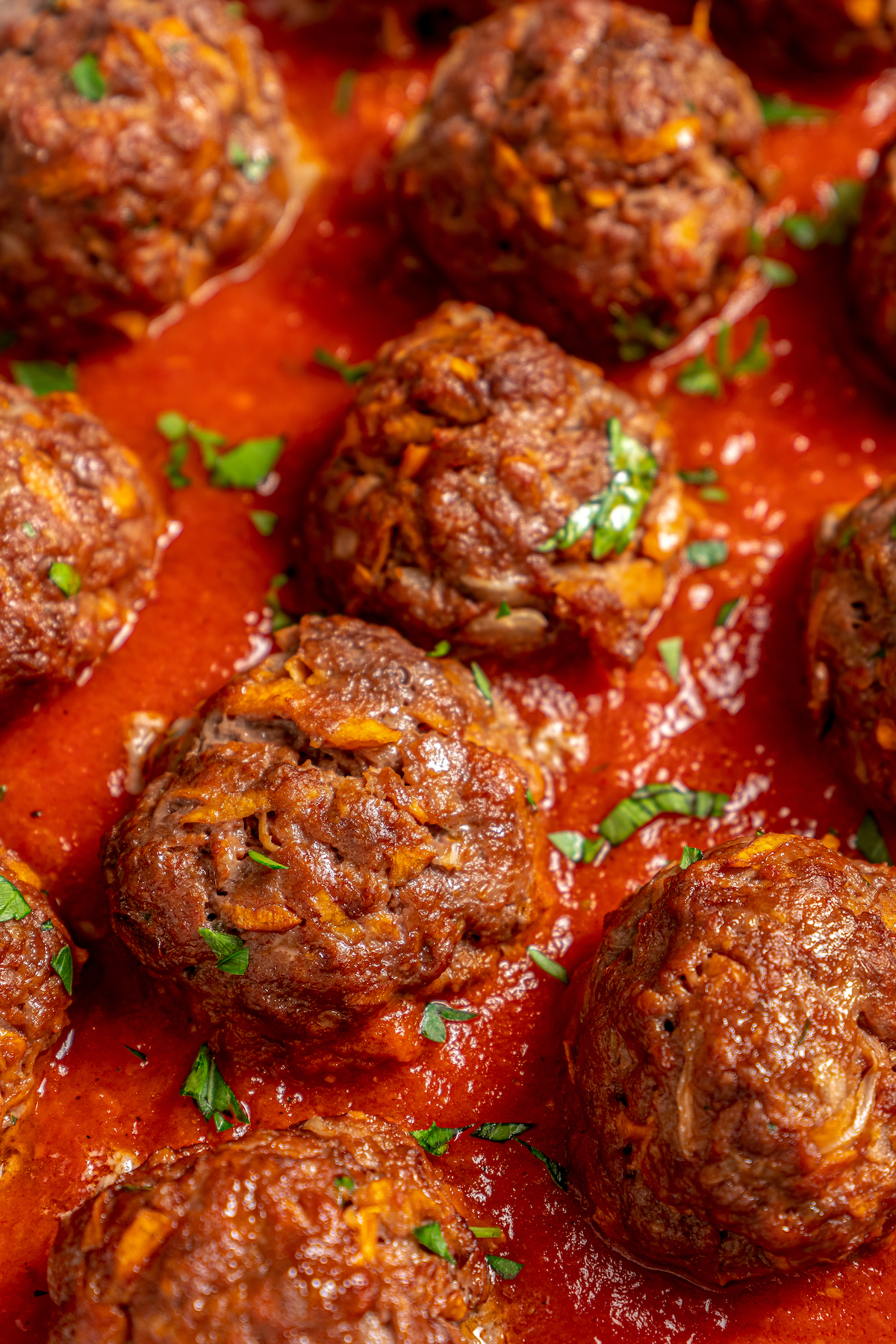 Close-up shot of homemade meatballs in sauce.