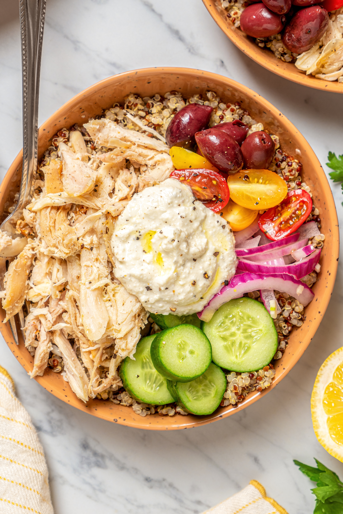 A bowl of quinoa with Greek feta cheese dressing and chicken.